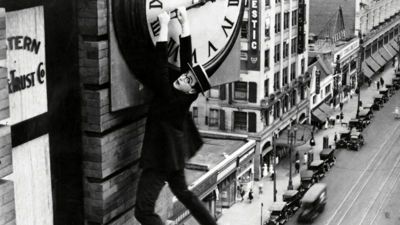Safety Last!  A Man Hanging From The Clock